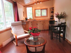 Kitchen with stove top, microwave, toaster oven and full fridge.