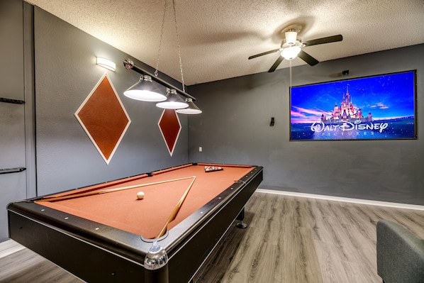 Private movie theater room with a pool table.