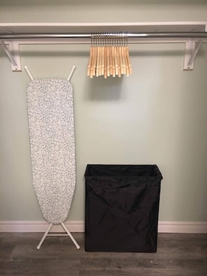 Ironing board, iron, and laundry baskets are provided