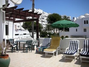 Terrace with sun beds and table and chairs