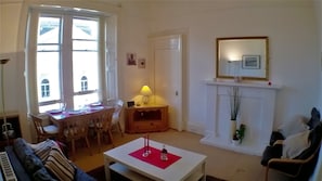 Living room with dining table and sofabed