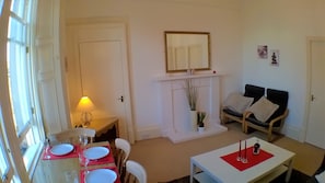 Living room with dining table and sofabed