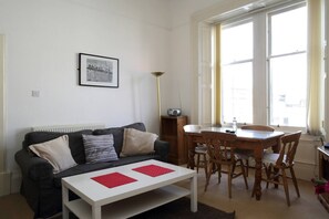 Living room with dining table and sofabed