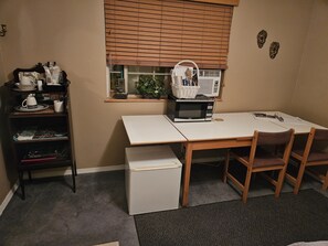 Table for work, as well as microwave, air conditioner, refrigerator, dishes view