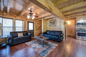 A great escape - Lustrous wood-planked walls and floors, beamed ceilings, plenty of sunshine and comfortable seating: Woodland Escape’s great room epitomizes Smoky Mountain ease.