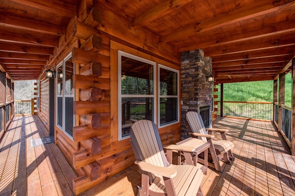 Savor the mountain air year-round - The covered wrap around deck is a shady space for kicking back with a cool drink on a hot summer day. And thanks to its fireplace, it’s also a cozy spot for admiring the brilliant autumn foliage. 