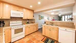 The kitchen has new white appliances...