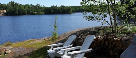 View of the lake including muskoka chairs