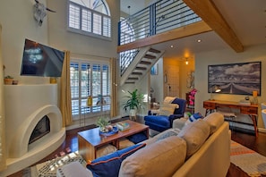 Relax in front of the adobe gas fireplace and towering two-story wall.
