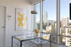 Dining area with seating for 4, sweeping city skyline and mountain views 
