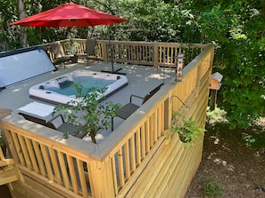 The hot tub is located on the deck outside Bluebirds Nest and one level up.