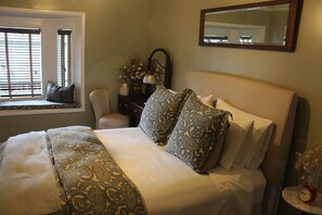 Queen size bed with featherbed in the winter.