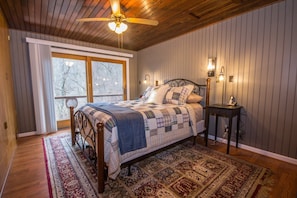 Queen size bed with balcony looking out to nature