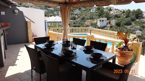 Quality al fresco dining table over looking the private pool.