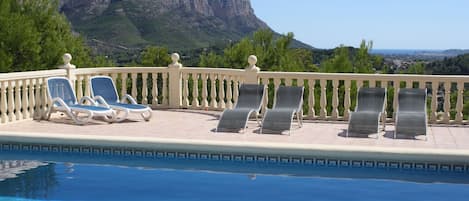 Pool surrounded by terracing with great views.