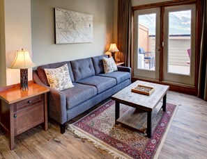 Living room and a welcoming private deck. 