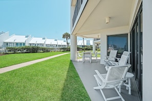 Ground floor patio steps away from the pool and beach