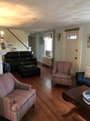 Other side of living rm. Entry at back to 1st floor bedrooms. Stairs to 2nd flr.