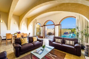 Living room and dining room area of Malta villa with pool