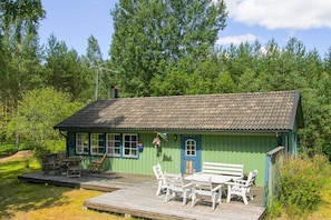 The cabin is surrounded by pine, spruce and birch trees. - photo from 2017