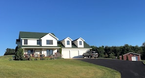 Paved driveway, 3 car garage and barn that can be used to store your equipment. 