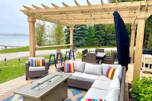 Comfy outdoor furniture, fire table and al fresco dining under the pergola.