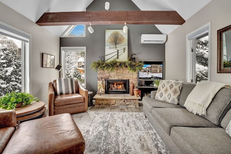 Living area with 2 leather chairs, sofabed (2020),gas fireplace (2022), smart tv