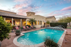 Courtyard view of north part of the main residence. Built-in BBQ, outdoor dining, lots of seating and heated pool and spa with deck jet fountains.