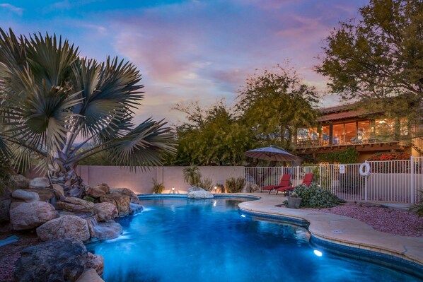 Discover a private paradise within a fenced pool area, boasting a relaxing spa, comfortable seating, and enchanting lighting. Escape and unwind in style.