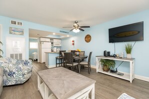 Open-concept living, dining, and kitchen area filled with coastal vibes