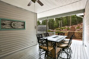 Sprawling patio with propane fire in the middle of 1 of 2 tables.