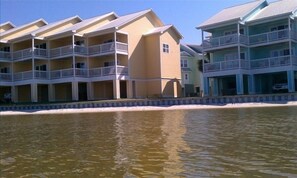 View looking back at condo from the water Townhouse is entire yellow end unit
