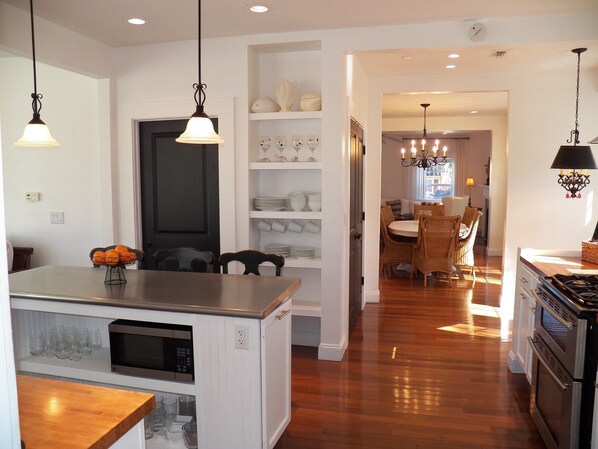 Large pantry and stainless open connecting two sitting areas  