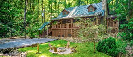 The recently built fire pit enhances the charm of this gorgeous log cabin.
