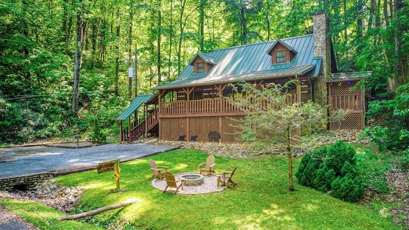 The recently built fire pit enhances the charm of this gorgeous log cabin.
