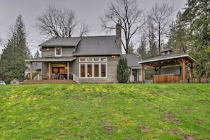 This 5-acre property boasts a large deck, private hot tub, and river views.