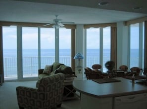 As you Enter, A wonderful view of the Beach and Water! Floor To Ceiling Glass!!