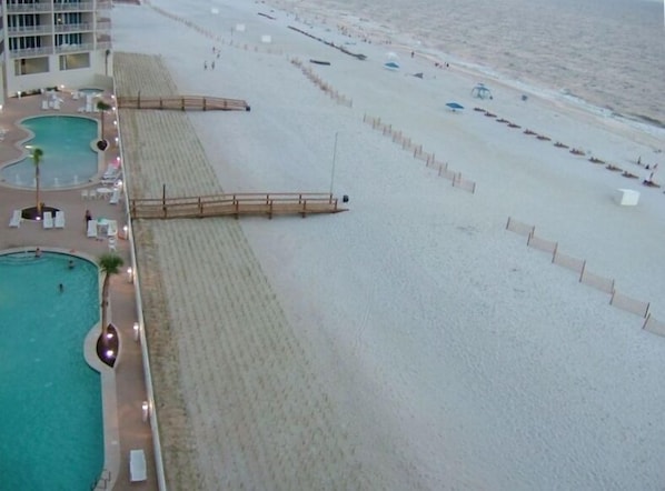 THE VIEW from the balcony at twilight - a jacuzzi is at the end of each pool