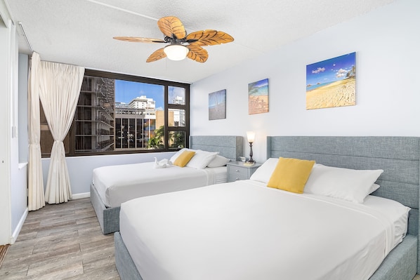 Bedroom with 2 queen-size beds and ceiling fan for air circulation