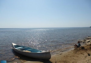 Kayak and canoe stored near shore