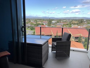 Enclosed private balcony with large outdoor dining setting