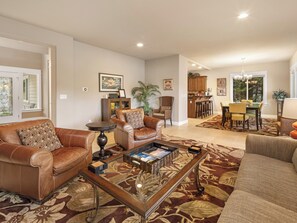 Comfortable living room with an open concept to the dining and kitchen nearby.