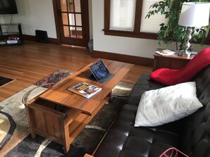 Coffee table lifts up to a desk position