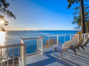 The balcony of the main floor that leads to the fire pit, jacuzzi, barbecue and stairway to the private beach.