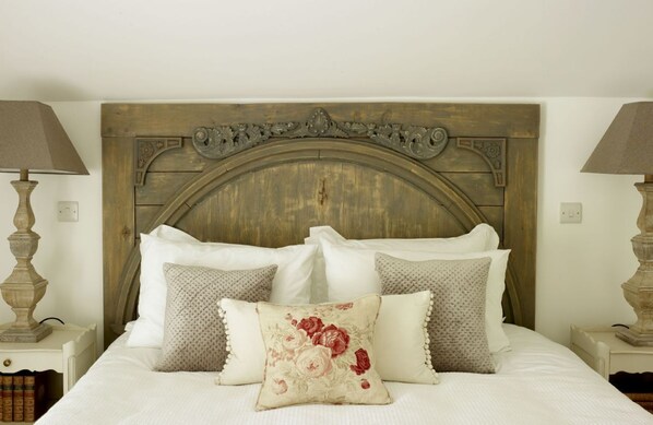Rectory Cottage, Stamford, Cambridgeshire: The hand-carved oak headboard completes this romantic space