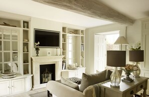 Ground floor: Open-plan New England-style kitchen and living room with limed oak floor and underfloor heating