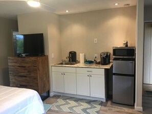 Kitchenette with dishes, glasses, toaster, blender, coffee maker, etc.