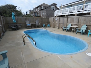 Large pool area with plenty of chairs to soak up the sun