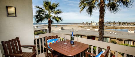 From your balcony you have a view of the ocean,  the sandy beach, the harbor, river, and mountains.