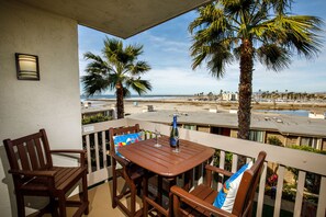 From your balcony you have a view of the ocean,  the sandy beach, the harbor, river, and mountains.